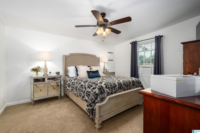 bedroom featuring light colored carpet, cooling unit, and ceiling fan