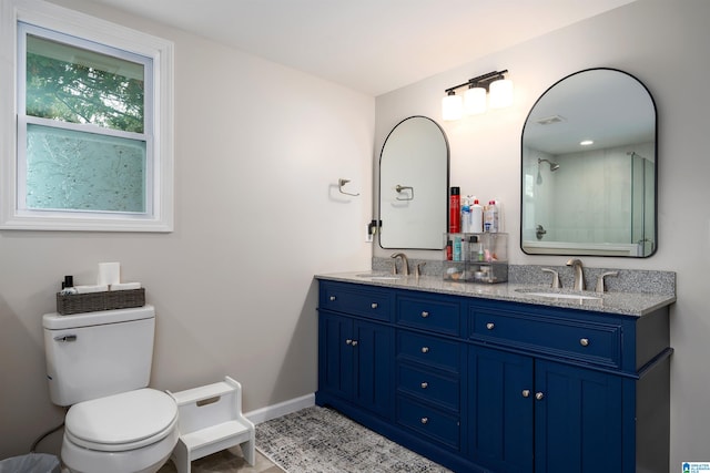 bathroom with vanity, toilet, and an enclosed shower