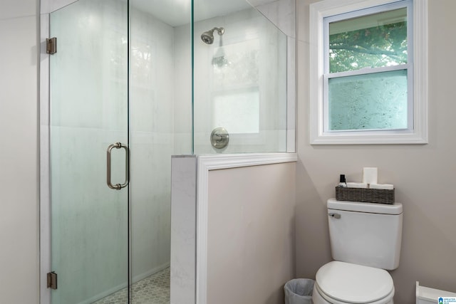 bathroom with toilet and a shower with shower door