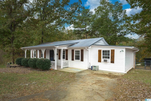 view of front of house with cooling unit and a porch