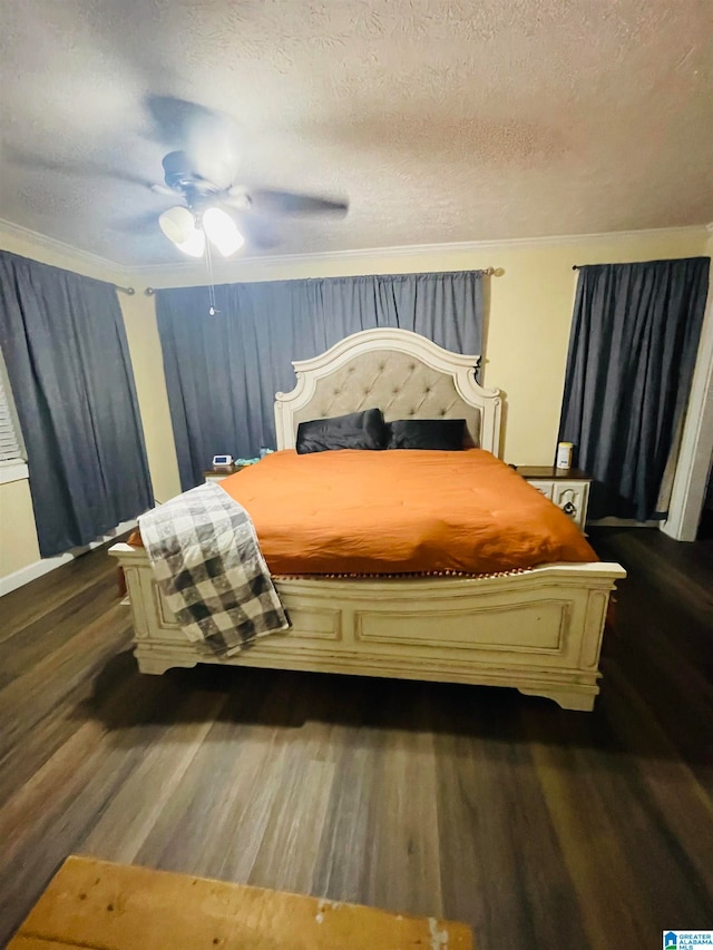 bedroom featuring ceiling fan, crown molding, dark wood-type flooring, and a textured ceiling