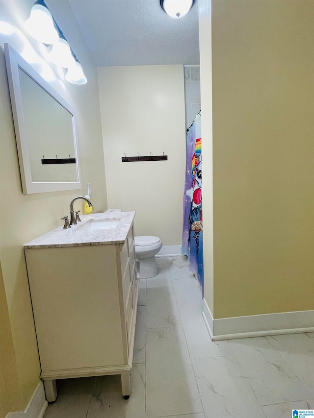 bathroom with a textured ceiling, vanity, toilet, and a shower with curtain