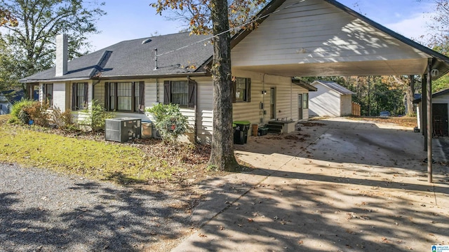 view of home's exterior with a carport and central AC unit