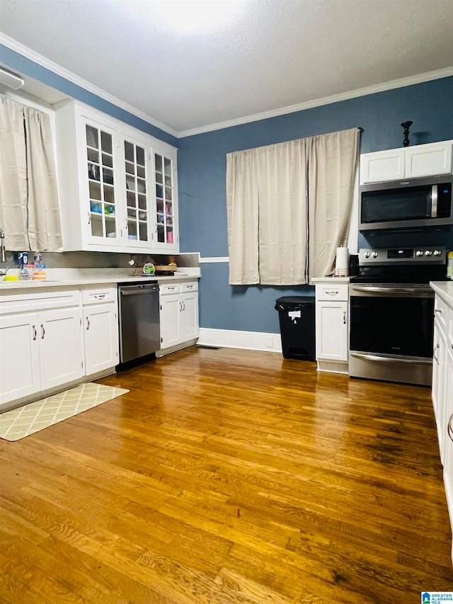 kitchen with sink, light wood-type flooring, white cabinetry, and stainless steel appliances