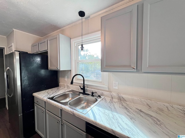 kitchen featuring gray cabinets, hanging light fixtures, sink, and ornamental molding