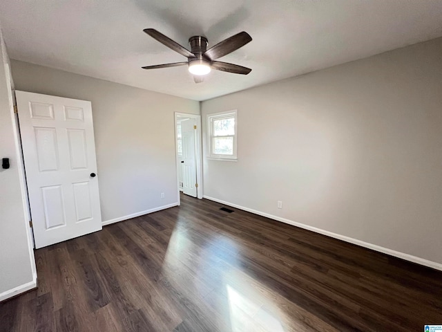 unfurnished bedroom with dark hardwood / wood-style flooring and ceiling fan