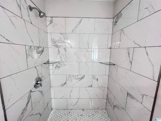 bathroom with a tile shower