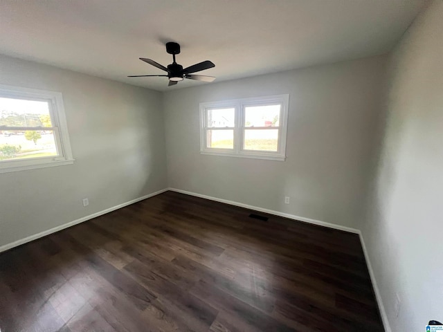 spare room with ceiling fan and dark hardwood / wood-style floors