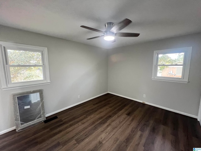 unfurnished room with dark hardwood / wood-style floors and ceiling fan