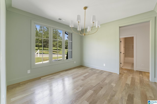 6558 Deerfoot Crossing Rd, Trussville, AL 35173 - spare room featuring a chandelier, light wood-style floors, and baseboards
