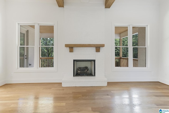 6558 Deerfoot Crossing Rd, Trussville, AL 35173 - unfurnished living room featuring wood finished floors, baseboards, beam ceiling, and a fireplace