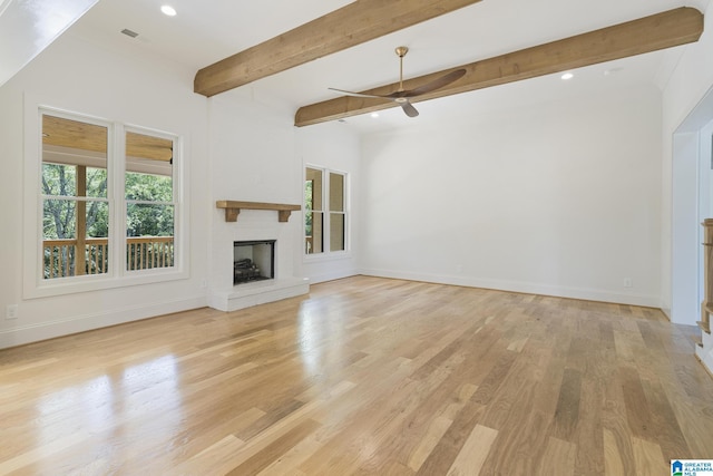 6558 Deerfoot Crossing Rd, Trussville, AL 35173 - unfurnished living room with a ceiling fan, a fireplace with raised hearth, light wood-type flooring, baseboards, and beam ceiling