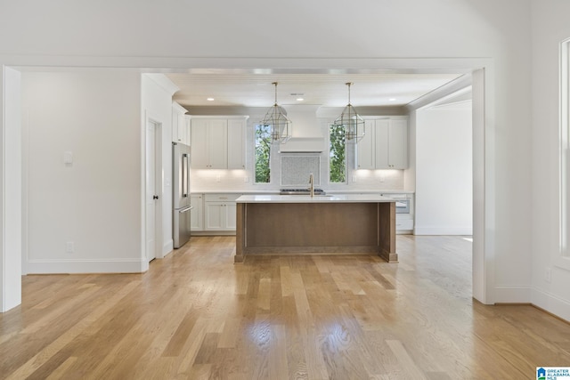 6558 Deerfoot Crossing Rd, Trussville, AL 35173 - kitchen featuring high end fridge, light countertops, decorative backsplash, light wood-style flooring, and baseboards