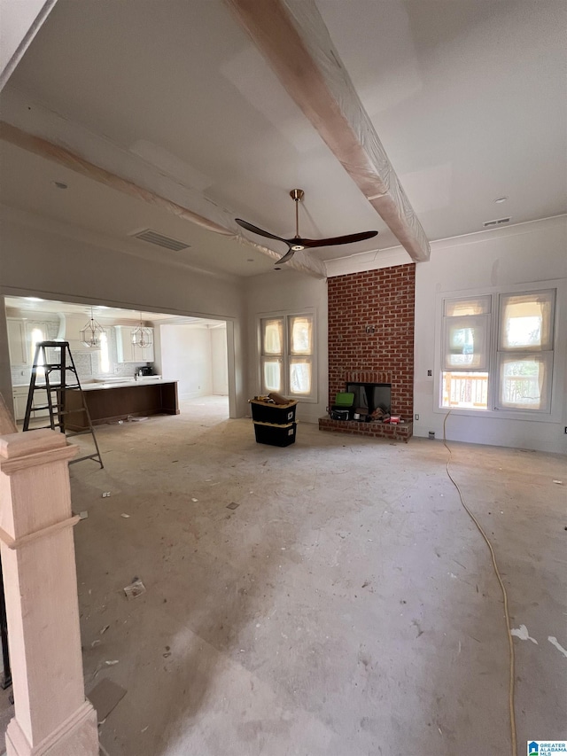 6558 Deerfoot Crossing Rd, Trussville, AL 35173 - unfurnished living room featuring a brick fireplace, healthy amount of natural light, ceiling fan, and concrete floors