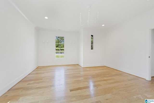 6558 Deerfoot Crossing Rd, Trussville, AL 35173 - spare room with crown molding, light wood-style flooring, baseboards, recessed lighting, and a chandelier