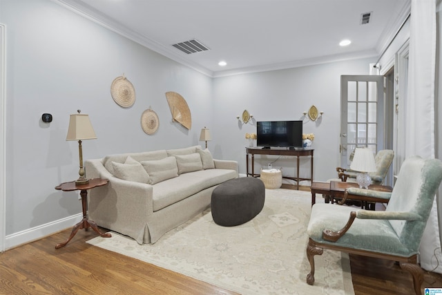 living room featuring hardwood / wood-style flooring and ornamental molding