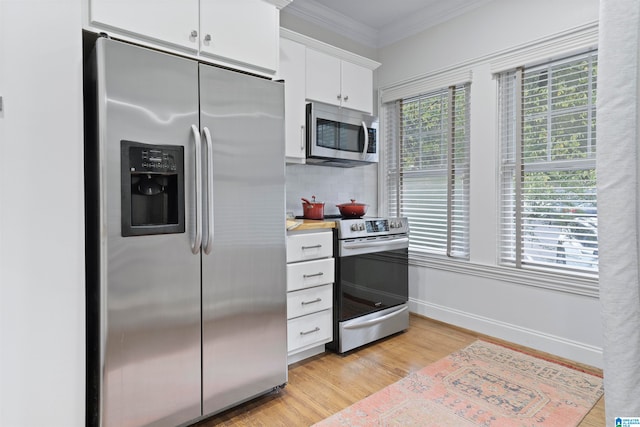 kitchen featuring light hardwood / wood-style floors, white cabinetry, appliances with stainless steel finishes, and a healthy amount of sunlight