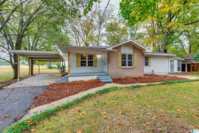 single story home featuring a front lawn and a carport