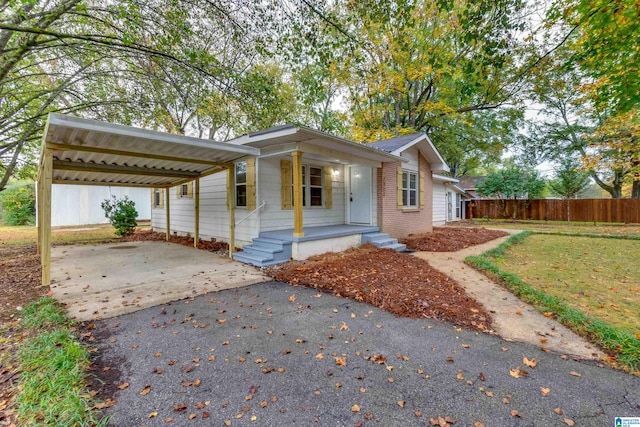 1821 20th St, Calera, AL 35040 - ranch-style house featuring driveway, covered porch, brick siding, and a carport