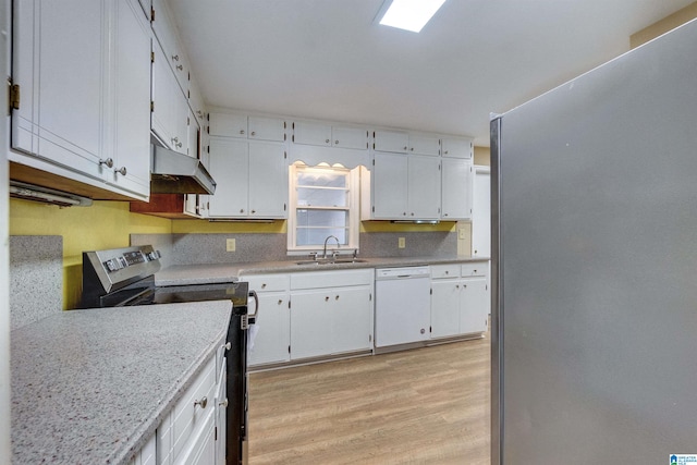 kitchen with stainless steel appliances, sink, light stone countertops, light hardwood / wood-style flooring, and white cabinets