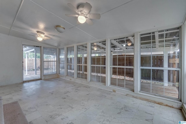 unfurnished sunroom featuring ceiling fan