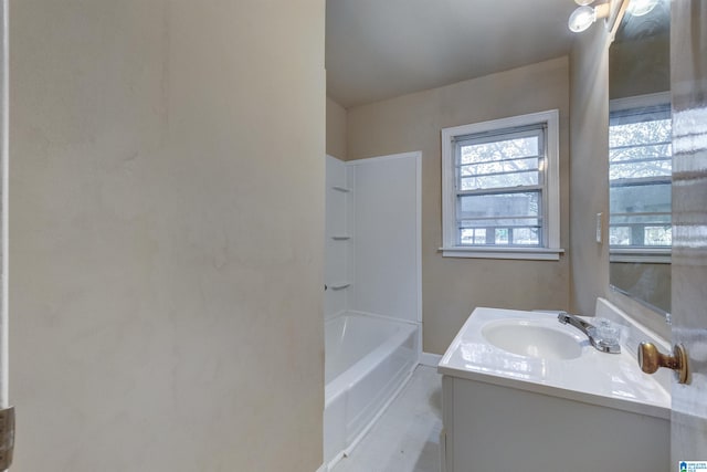 bathroom featuring a tub to relax in and vanity