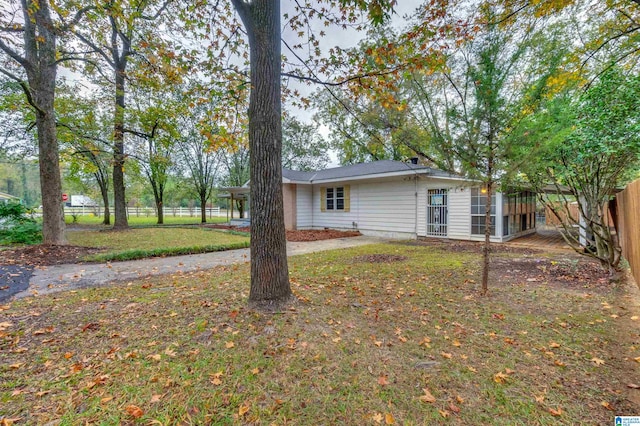 back of house with a lawn