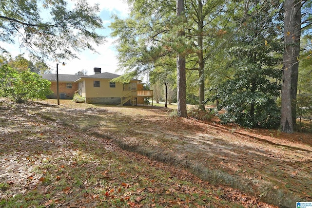 view of yard featuring a wooden deck