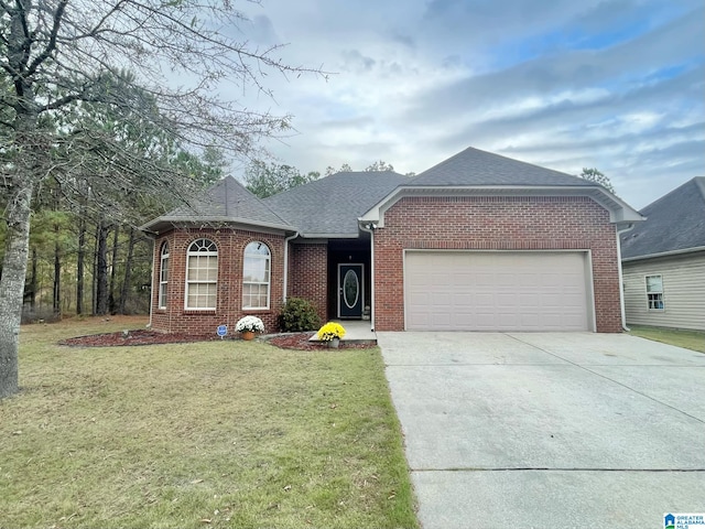 view of front of property with a garage and a front lawn