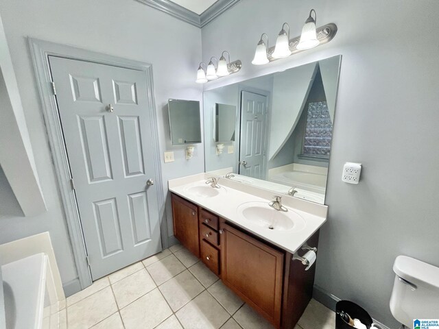 bathroom with ornamental molding, vanity, a bathing tub, tile patterned floors, and toilet