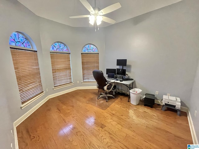 home office with light hardwood / wood-style floors, ceiling fan, and lofted ceiling