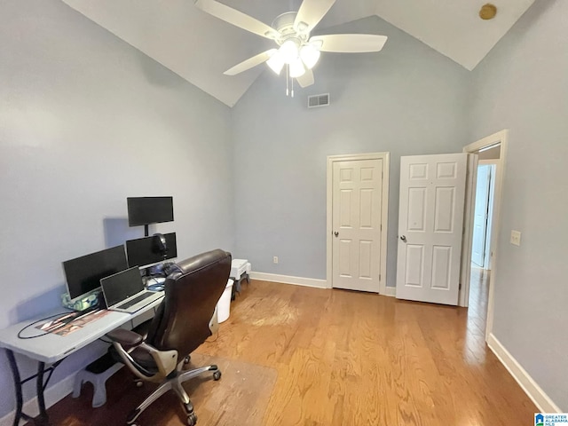 home office featuring high vaulted ceiling, light hardwood / wood-style floors, and ceiling fan