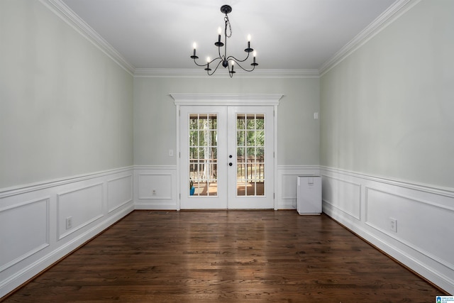 unfurnished dining area featuring ornamental molding, french doors, dark hardwood / wood-style floors, and a chandelier