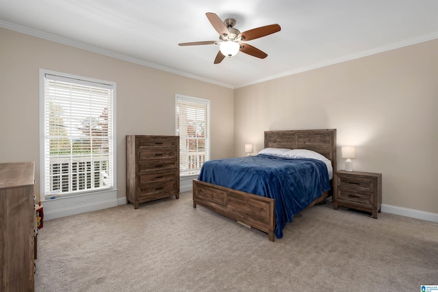 carpeted bedroom with ceiling fan and crown molding