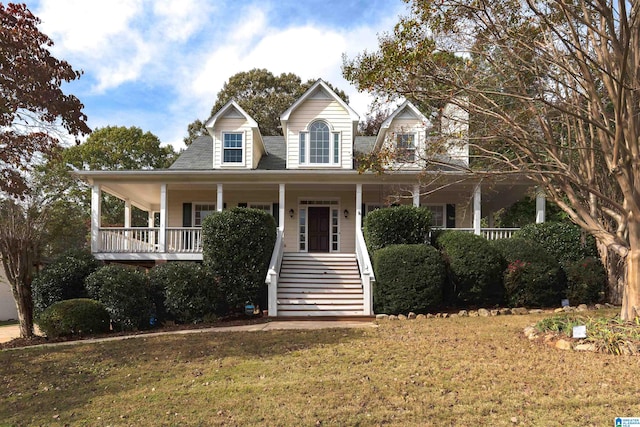 farmhouse with a front lawn and covered porch