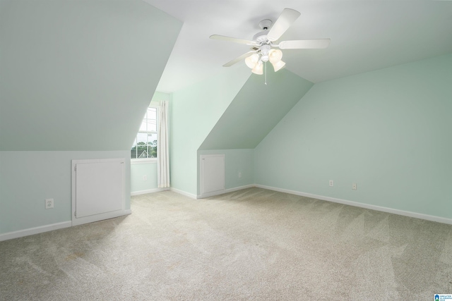 bonus room featuring lofted ceiling, light carpet, and ceiling fan