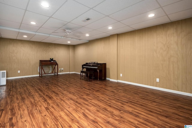 spare room with hardwood / wood-style floors, ceiling fan, and a paneled ceiling