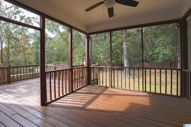 unfurnished sunroom featuring ceiling fan