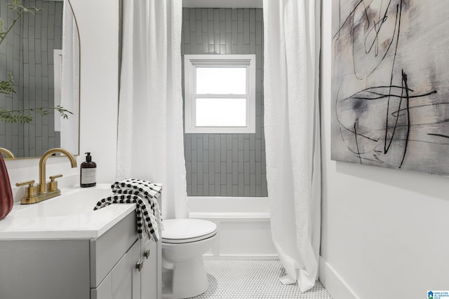 full bathroom with tile patterned floors, vanity, shower / bath combo with shower curtain, and toilet