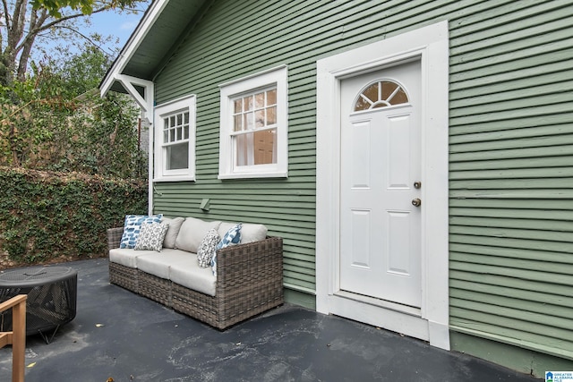 view of exterior entry featuring a patio