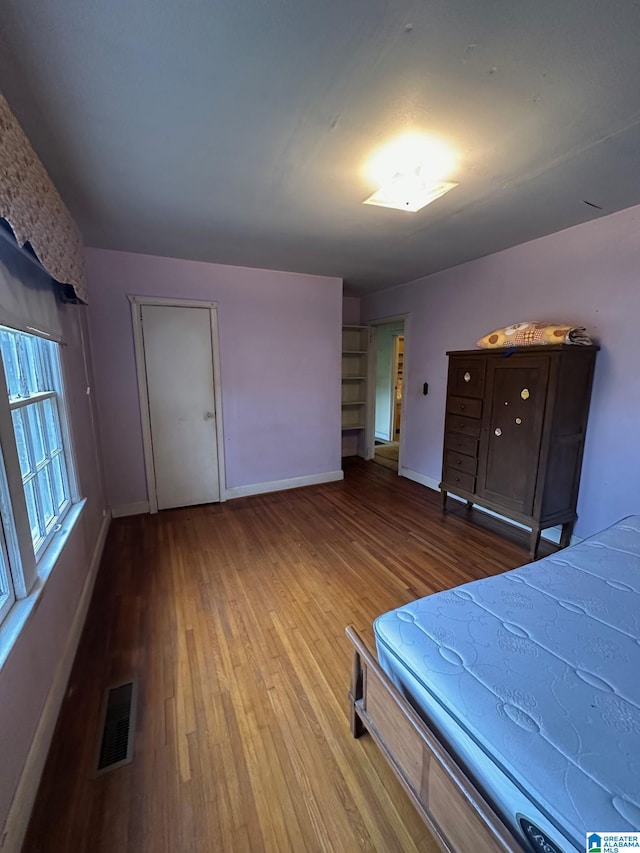 unfurnished bedroom with hardwood / wood-style flooring