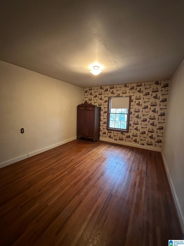 spare room with dark wood-type flooring