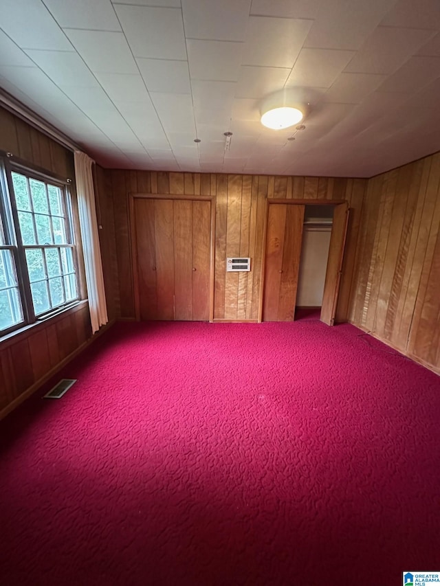 spare room featuring wood walls