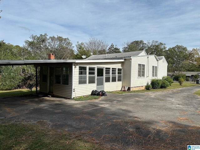 view of home's exterior with a carport