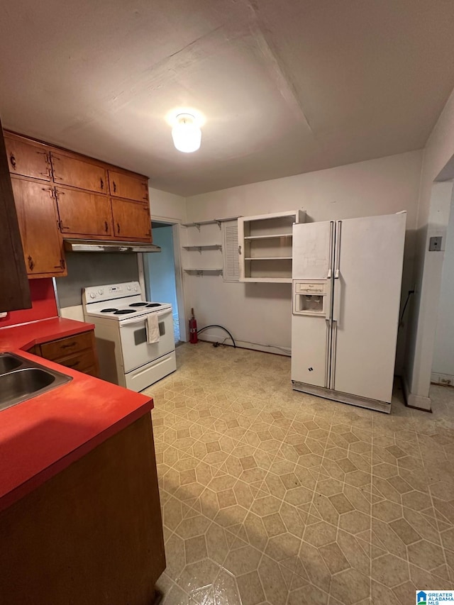 kitchen featuring white appliances and sink