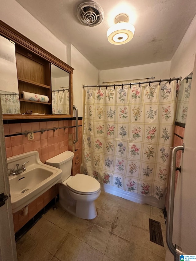 full bathroom with sink, shower / bath combination with curtain, tile walls, toilet, and decorative backsplash