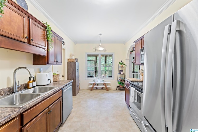 kitchen with hanging light fixtures, sink, ornamental molding, and stainless steel appliances