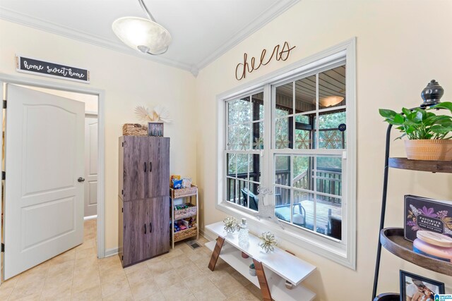 doorway to outside featuring crown molding