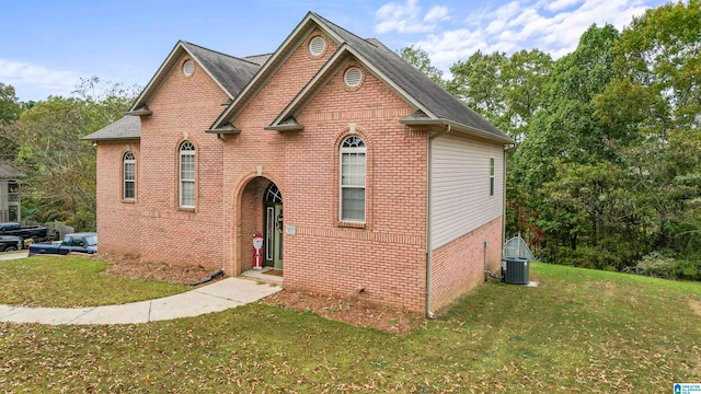 view of front of home with cooling unit and a front lawn