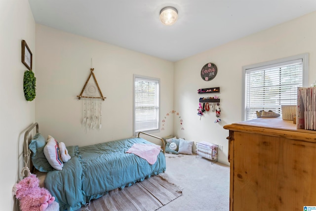 bedroom with carpet flooring and multiple windows